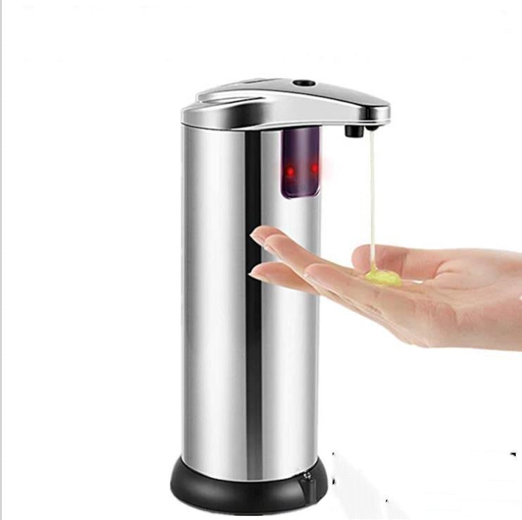 Silver automatic soap dispenser releasing liquid soap into an outstretched hand beneath its sensor-operated outlet.
