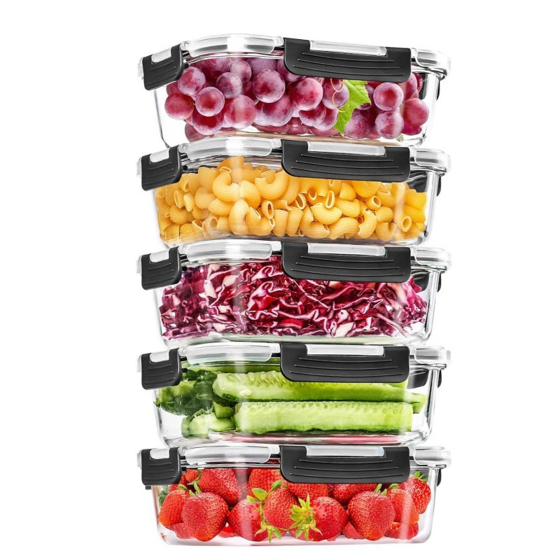 Five stacked Glassora glass food containers with black snap-lock lids holding grapes, pasta, red cabbage, cucumber, and strawberries.
