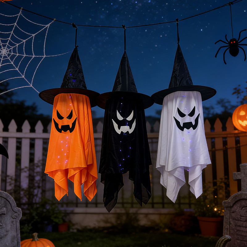 Glowing ghost decorations for Halloween featuring three light-up witch hat ghosts in orange, black, and white.