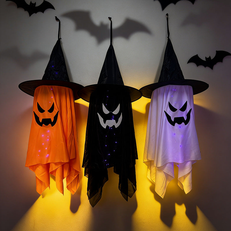 Glowing ghost decorations for Halloween featuring witch hat ghosts in orange, black, and white colors with lights.