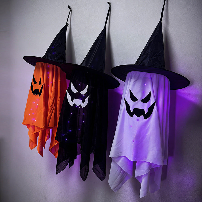 glowing ghost decorations for Halloween, light up witch hat ghosts in orange, black, and white hanging decor.